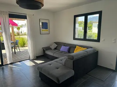 a living room with a couch and a chair at Villa avec piscine privée Santa Maria Poggio in Santa-Maria-Poggio