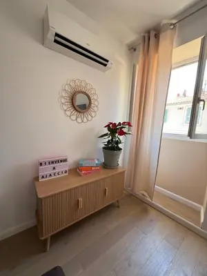 a room with a table with a plant on it at T2 Cosy HYPER CENTRE AJACCIO in Ajaccio
