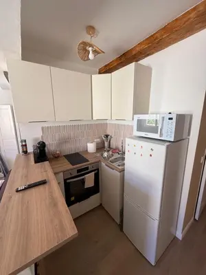 a kitchen with a white refrigerator and a microwave at T2 Cosy HYPER CENTRE AJACCIO in Ajaccio