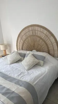 a large bed with white sheets and pillows at A LAVANDA Maison BONIFACIO in Bonifacio