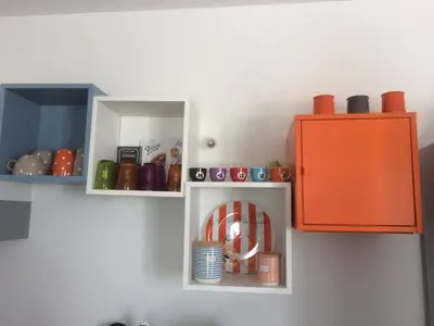 a toy kitchen with an orange cabinet and plates at A LAVANDA Maison BONIFACIO in Bonifacio