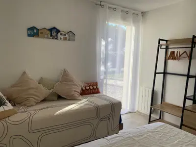 a living room with a bed and a window at A LAVANDA Maison BONIFACIO in Bonifacio