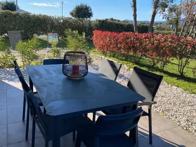 a blue table and chairs with a basket on it at A LAVANDA Maison BONIFACIO in Bonifacio