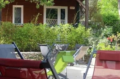 a group of chairs sitting in front of a house at Résidence L'araguina in Bonifacio