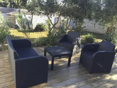 two chairs and a table and two chairs on a deck at Mini-villa 1 in Bonifacio