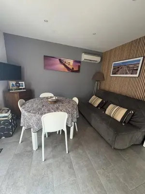 a living room with a table and a couch at Mini-villa 1 in Bonifacio