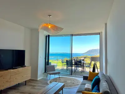 a living room with a couch and a tv at Loft Centre-Ville Vue Mer in Porto-Vecchio