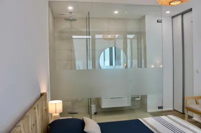 a room with a bed and a mirror at Loft Centre-Ville Vue Mer in Porto-Vecchio