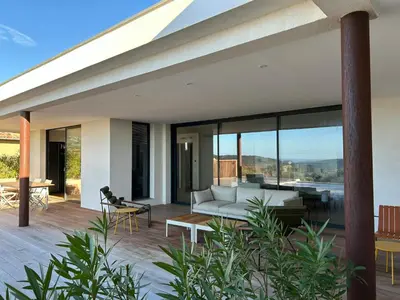an outdoor patio with a couch and a table at Contemporary Villa In Southern Corsica in Monacia-dʼAullène