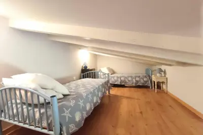 a bedroom with two bunk beds and wooden floors at Beautiful T2 in residence with swimming pools in Grosseto-Prugna