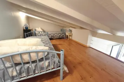 a bedroom with two bunk beds in a attic at Beautiful T2 in residence with swimming pools in Grosseto-Prugna