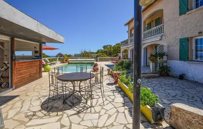 a patio with a table and chairs next to a house at Gorgeous Home In Cervione With Wifi in Cervione