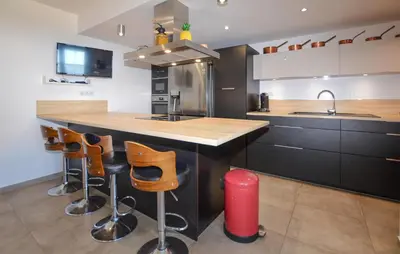 a kitchen with a counter and some stools in it at Gorgeous Home In Cervione With Wifi in Cervione