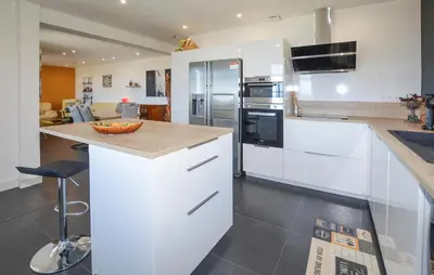 a kitchen with white cabinets and a counter top at Gorgeous Home In Cervione With Wifi in Cervione