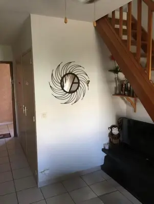 a spiral painting on a wall in a living room at Les Marines de Moriani in San-Nicolao