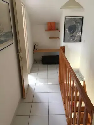 a hallway with a staircase with a bench on the floor at Les Marines de Moriani in San-Nicolao