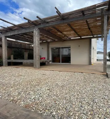 an outdoor patio with a wooden pergola at Villa-de Luxe-Salle de bain-Vue sur la campagne à 5 minutes de la mer Qui est composé de 5 chambres in Venzolasca