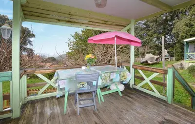 a table with a pink umbrella on a deck at Gorgeous Stacaravan In Casalabriva in Casalabriva