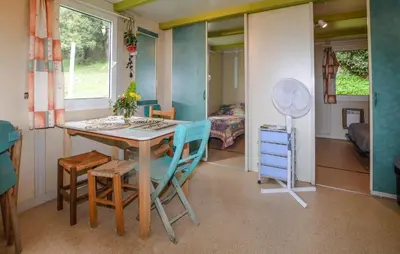 a room with a table and chairs and a bedroom at Gorgeous Stacaravan In Casalabriva in Casalabriva