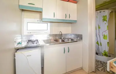 a small kitchen with a sink and a stove at Gorgeous Stacaravan In Casalabriva in Casalabriva