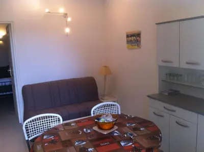 a living room with a couch and a table at U Paesu in Zonza