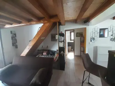 a living room with a couch and wooden ceilings at Maison de campagne idéale pour séjour en famille in Porto-Vecchio