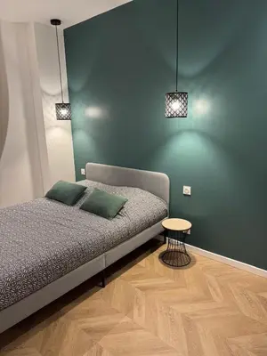 a bedroom with a bed and a small table at Appartement Ajaccio in Ajaccio
