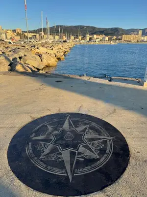 a star on the ground on a beach next to the water at Appartement Ajaccio in Ajaccio