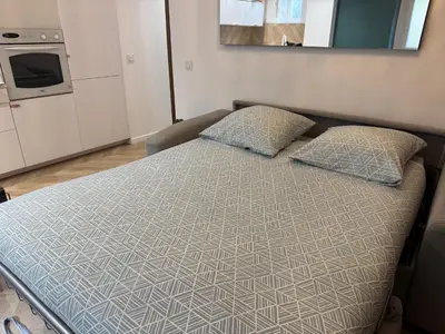a bed with two pillows in a small room at Appartement Ajaccio in Ajaccio