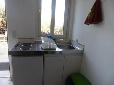 a small kitchen with a sink and a window at Maquis et Mer in Sollacaro