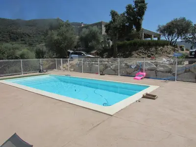 a large swimming pool in a yard at Maquis et Mer in Sollacaro