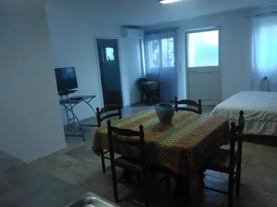 a dining room with a table and a bed at Maquis et Mer in Sollacaro