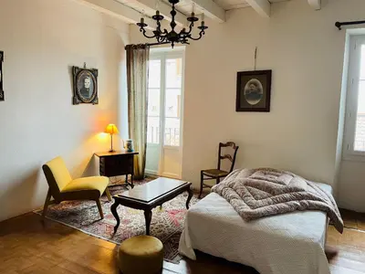 a bedroom with a bed and a table and chairs at Grande Maison de village ZONZA in Zonza