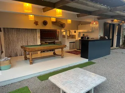 a patio with a pool table and a kitchen at Bas de Villa indépendant San Benedetto in Alata