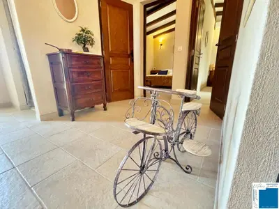 a bike parked in a hallway with a dresser at A Sérénità - Bergerie - Piscine Privée in Porto-Vecchio