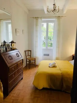 a bedroom with a bed and a dresser and a window at Maison centre village ZONZA in Zonza
