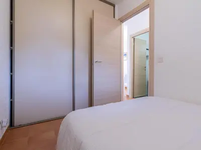 a bedroom with a white bed and a mirror at Apartment Casa Antonio by Interhome in Linguizzetta