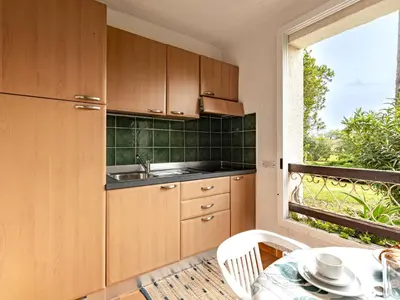 a kitchen with a sink and a table and a window at Apartment Casa Antonio by Interhome in Linguizzetta