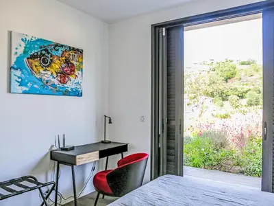 a bedroom with a bed and a desk and a window at Villa La Cupulatta by Interhome in Sainte-Lucie de Porto-Vecchio