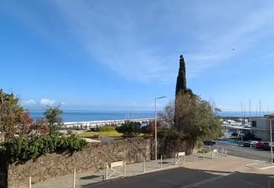 a view of the ocean from a parking lot at Appartement cosy Vue Mer et Montagne in Sari Solenzara