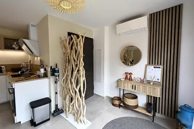 a living room with a table and a mirror at U Sognu - Superbe T3 à Bonifacio classé 4 étoiles in Bonifacio