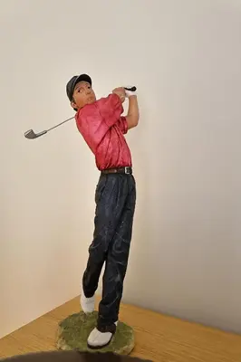 a figurine of a man swinging a golf club at U Sognu - Superbe T3 à Bonifacio classé 4 étoiles in Bonifacio