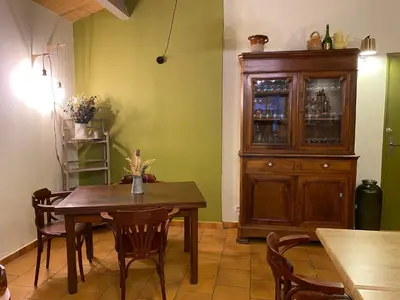 a dining room with a table and a wooden cabinet at Gite d'étape Auberge Luna Piena in Santa-Reparata-di-Moriani