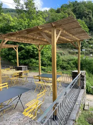 a wooden pavilion with picnic tables and chairs at Gite d'étape Auberge Luna Piena in Santa-Reparata-di-Moriani