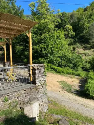 a gazebo with a stone wall and a bench at Gite d'étape Auberge Luna Piena in Santa-Reparata-di-Moriani