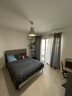 a bedroom with a bed with a teddy bear on it at Loretto proche centre ville et plage in Ajaccio