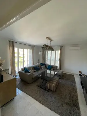a living room with a couch and a glass table at Loretto proche centre ville et plage in Ajaccio
