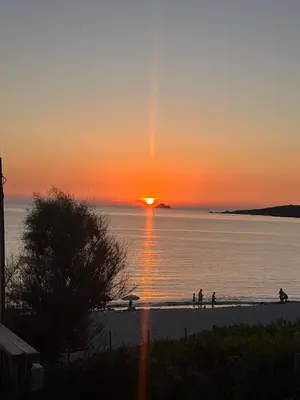 people walking on the beach at the sunset at Loretto proche centre ville et plage in Ajaccio