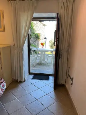an open door to a patio with a table at Casuccia Piazza di i Fiori in Penta-di-Casinca
