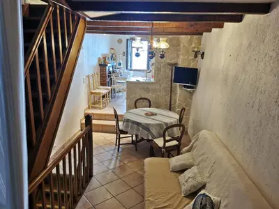 a living room with a table and a dining room at Casuccia Piazza di i Fiori in Penta-di-Casinca